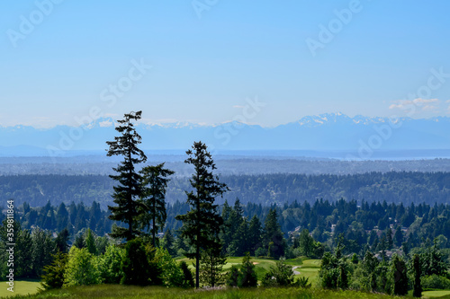 Newcastle golf course on a spring day; golf course can be seen partially in the front and the Olympic Mountains far away in the back. photo