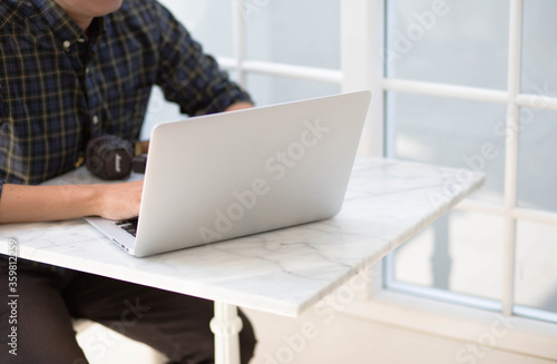 businessman working on laptop in cafe. © bosavang