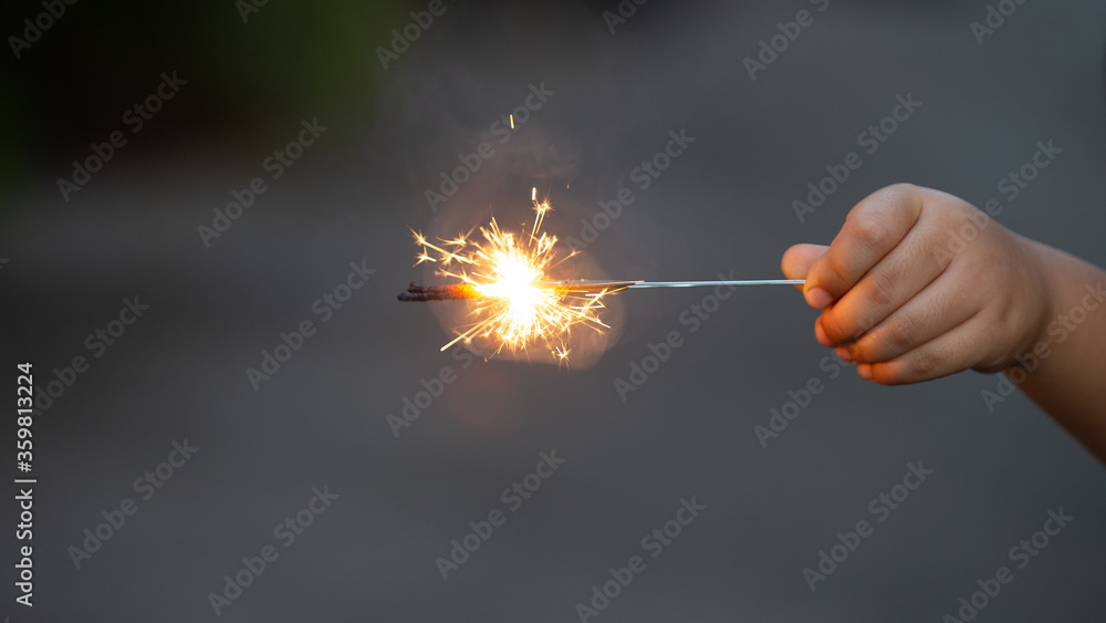 hand with sparkler hand with sparkler