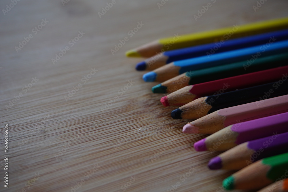 Arrangement of colored pencils on wooden background. copy space for text. back to school concept. rustic vintage concept Arrangement of colored pencils on wooden background. copy space for text. back to school concept. rustic vintage concept