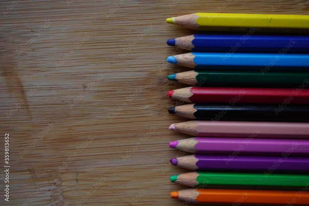 Arrangement of colored pencils on wooden background. copy space for text. back to school concept. rustic vintage concept Arrangement of colored pencils on wooden background. copy space for text. back to school concept. rustic vintage concept