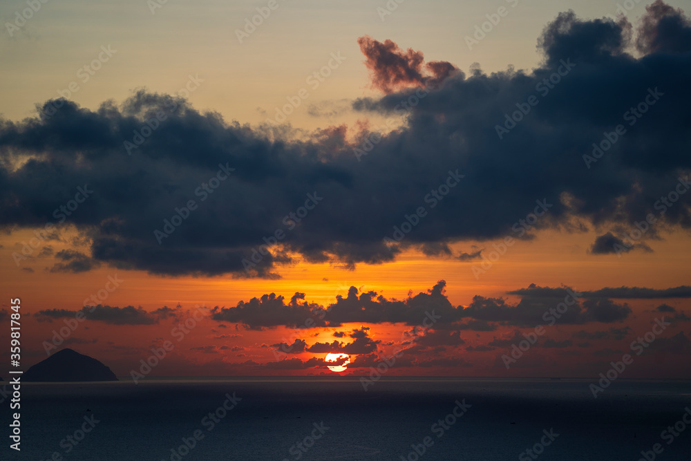 Landscape sunrise on Hon Chong cape, Nha Trang, Vietnam. Travel and nature concept. Morning sky, clouds, sun and sea water