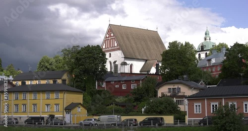 4K video of Porvoo vintage red wooden buildings, Porvoo Cathedral, yachts and boats in Porvoonjoki River near town center on sunny summer day in Finland, northern Europe photo