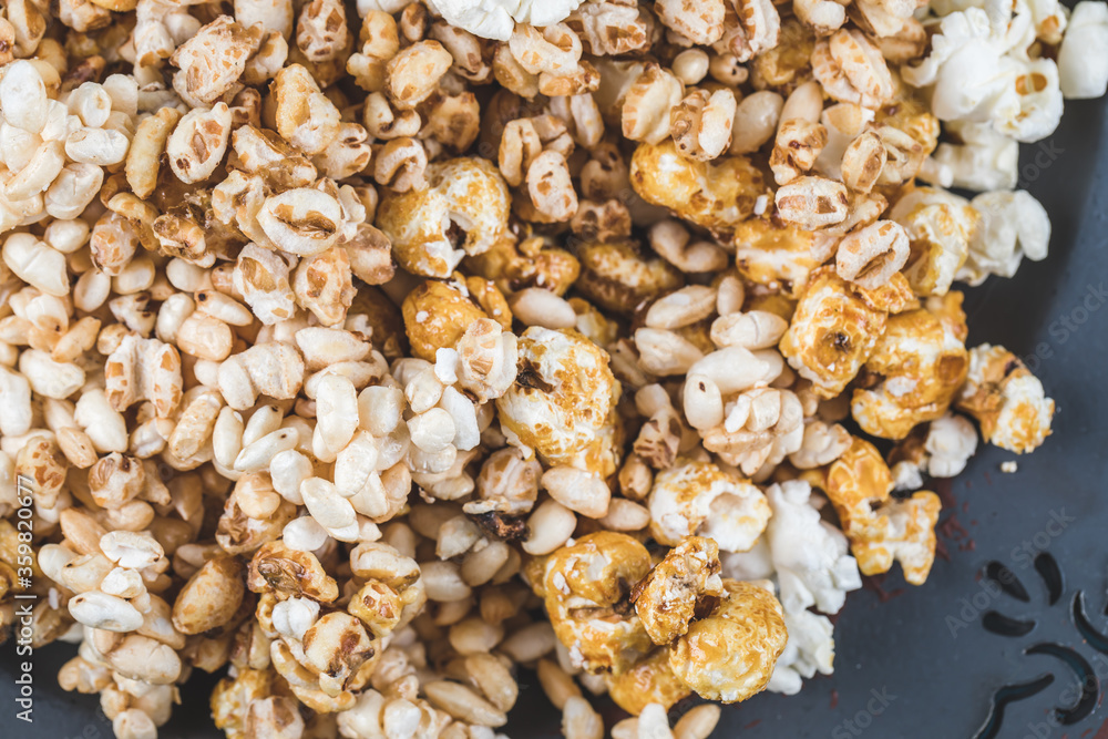 Popcorn with caramel corn and kettle corn on blue background Popcorn with caramel corn and kettle corn on blue background