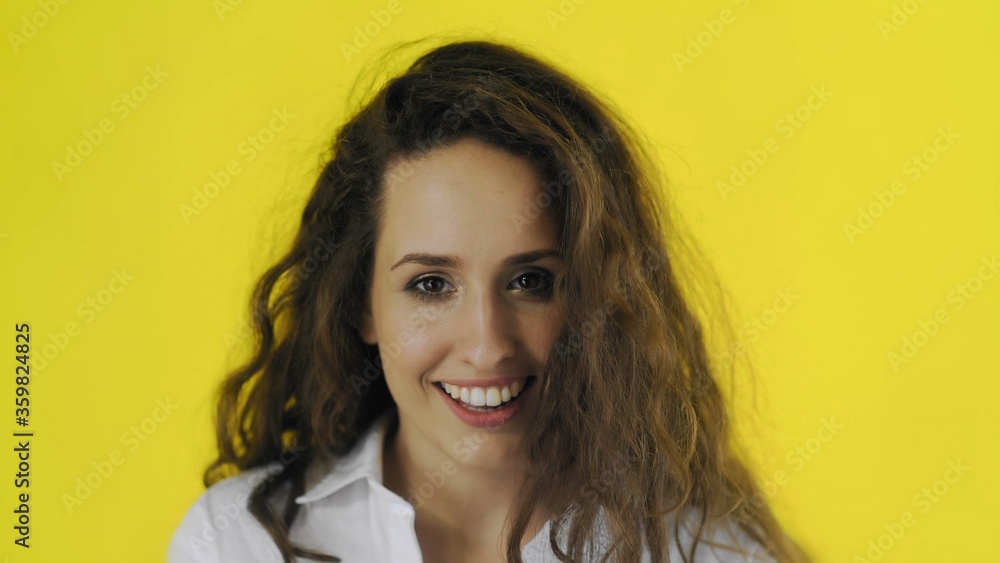 Portrait of sexy woman looking at the camera and flirting in studio with yellow Background. Portrait of sexy woman looking at the camera and flirting in studio with yellow Background.