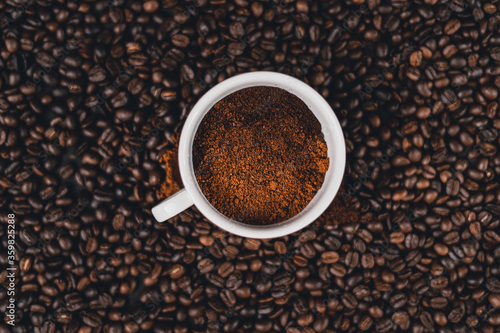 Fototapeta premium Ground coffee in a spoon on the background