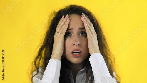 Billede på lærred Beautiful woman with curly hairs have terrible headache