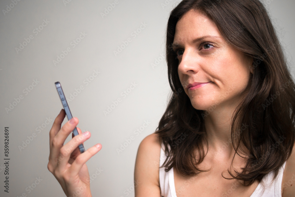 Face of beautiful woman thinking while using phone Face of beautiful woman thinking while using phone