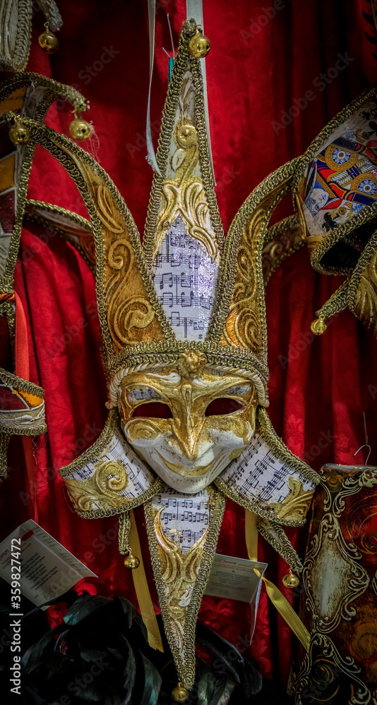 Traditional ornate Venetian carnival masks on display at a craftsman workshop studio and store in Venice, Italy