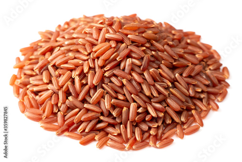 heap of raw red long-grained rice isolated on white background