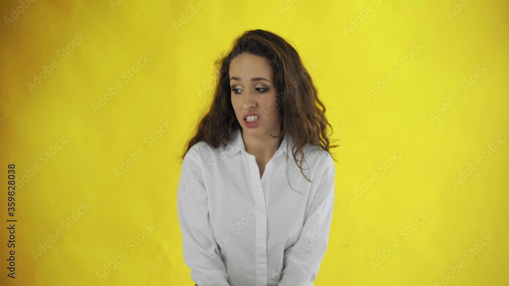 Portrait of a young woman feeling repulsion and disgust Portrait of a young woman feeling repulsion and disgust