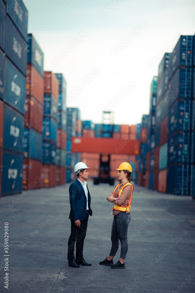 Fototapeta premium Executives and chief engineers are currently inspecting work in the international shipping depots, container yard, Concepts of importing and exporting lndustrial business