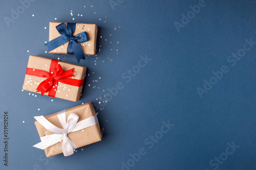 4th of July American Happy Independence Day card with gift boxes in national colors on trendy classic blue background, Flat lay, top view, copy space, banner
