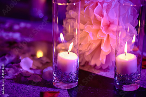Purple Candles and flowers as decorations at night wedding ceremony