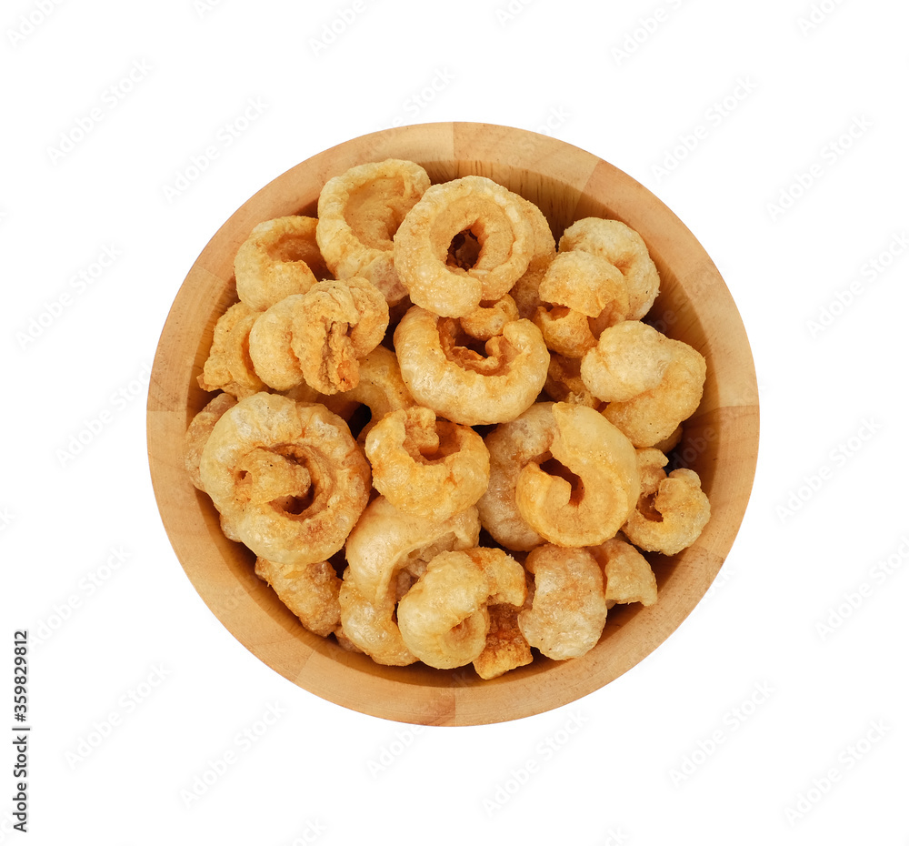 Pork snack, pork rind, pork scratching, pork crackling in wooden bowl isolated on the white background, top view. Pork snack, pork rind, pork scratching, pork crackling in wooden bowl isolated on the white background, top view.