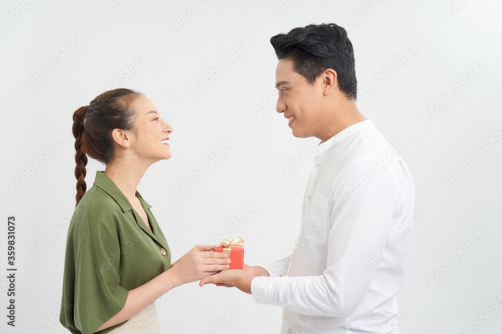 Happy Man giving a gift to his girlfriend. Happy Man giving a gift to his girlfriend.