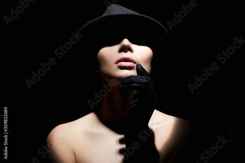 Beautiful woman in hat and gloves. Retro style portrait