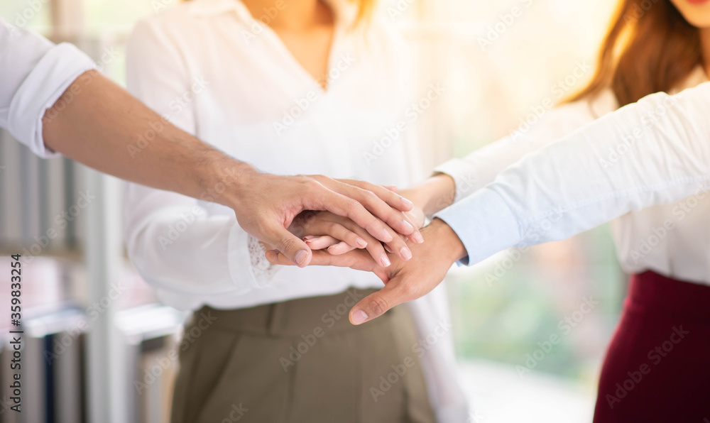 Business people showing unity with their hands together Business people showing unity with their hands together
