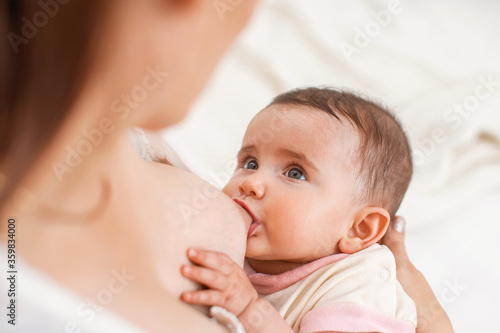 Process of breastfeeding. Mother is breastfeeding a child.