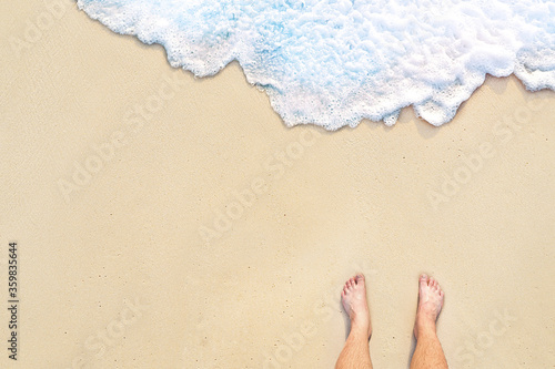 standing on the beach with wave motion coming to the foot