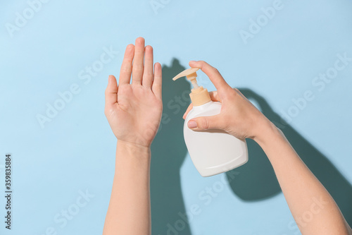 Woman washing hands on color background