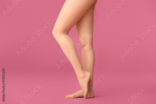 Beautiful young woman in tights on color background