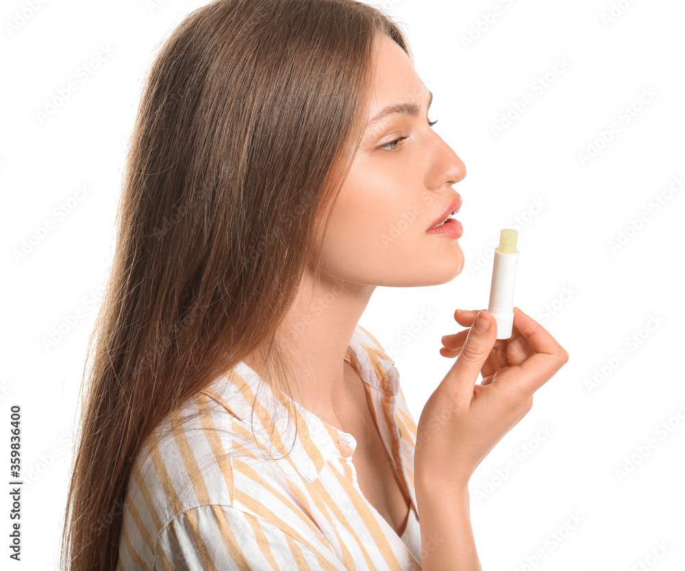 Beautiful young woman with lip balm on white background Beautiful young woman with lip balm on white background