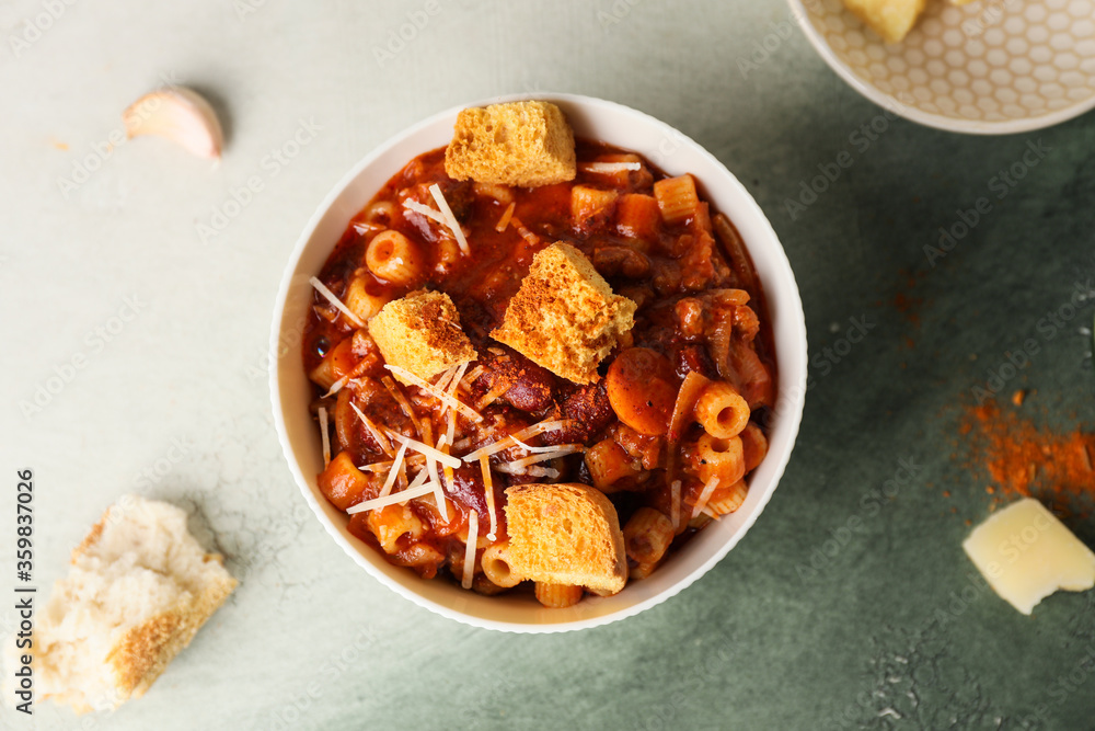 Bowl with tasty pasta and beans on color background Bowl with tasty pasta and beans on color background
