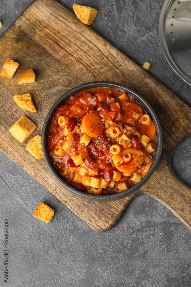 Bowl with tasty pasta and beans on dark background Bowl with tasty pasta and beans on dark background