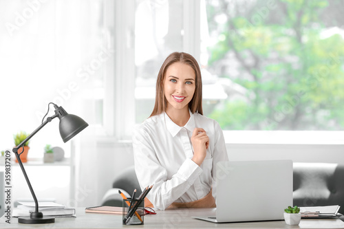 Young businesswoman at tabl...