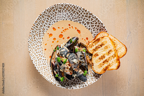 Plate of mussels with creme dubarry in restaurant photo