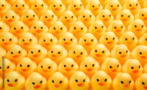 a lot of rubber ducks standing in a order