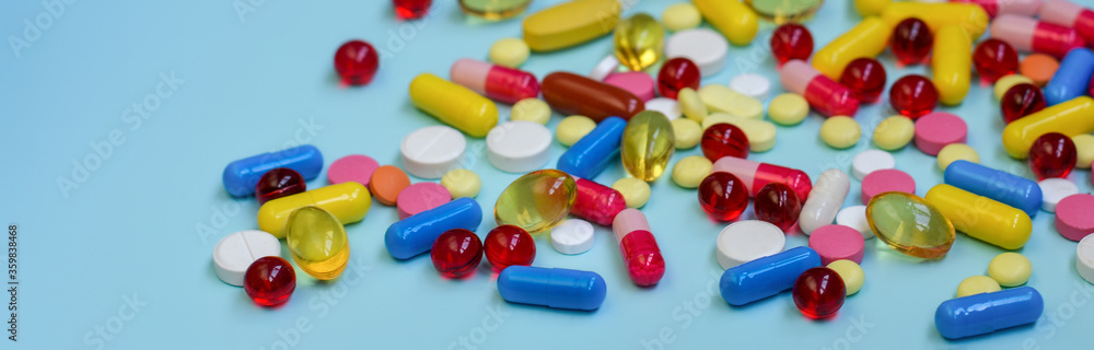 Multi-colored tablets, capsules, vitamins, supplements. Сoncept of treatment and healthcare. Multi-colored tablets, capsules, vitamins, supplements. Сoncept of treatment and healthcare.