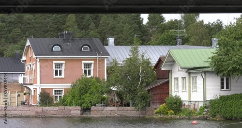 4K video of Porvoo vintage red wooden buildings, Porvoo Cathedral, yachts and boats in Porvoonjoki River near town center on sunny summer day in Finland, northern Europe photo