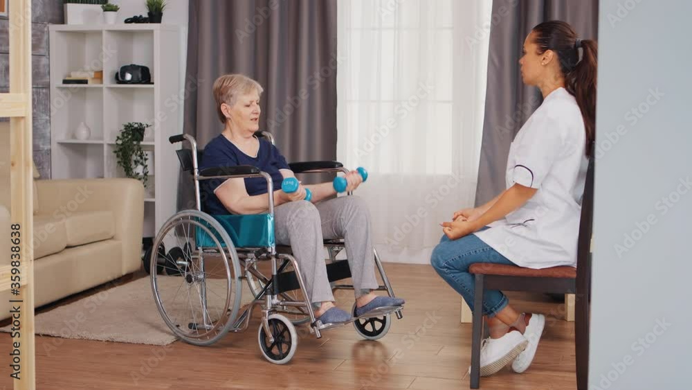 Old lady in wheelchair doing physical rehabilitation with nurse. Training, sport, recovery and lifting, old person retirement home, healthcare nursing, health support, social assistance, doctor and Old lady in wheelchair doing physical rehabilitation with nurse. Training, sport, recovery and lifting, old person retirement home, healthcare nursing, health support, social assistance, doctor and