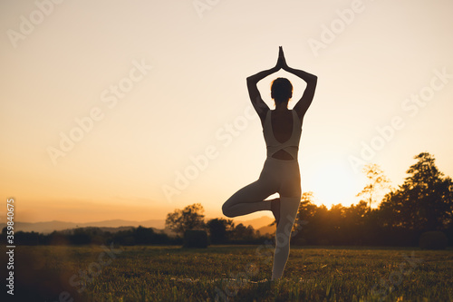 Woman yoga. Young female doing yoga on nature outdoors.