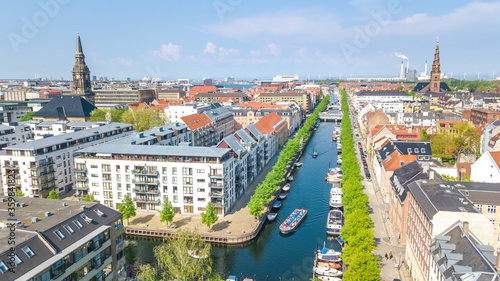 Beautiful aerial view of Copenhagen skyline from above, Nyhavn historical pier port and canal with color buildings and boats in the old town of Copenhagen, Denmark
