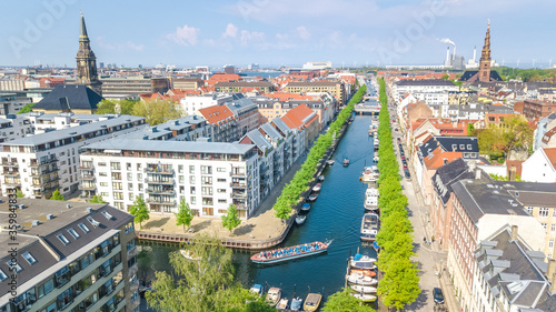 Beautiful aerial view of Copenhagen skyline from above, Nyhavn historical pier port and canal with color buildings and boats in the old town of Copenhagen, Denmark
