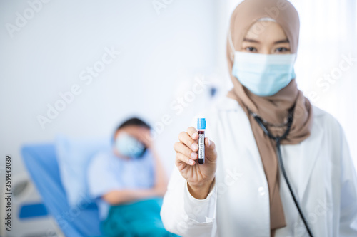The beautiful Muslim doctor wear hijab works at the hospital to take care the elderly patient. The concept of aging society under the COVID-19 pandemic situation.