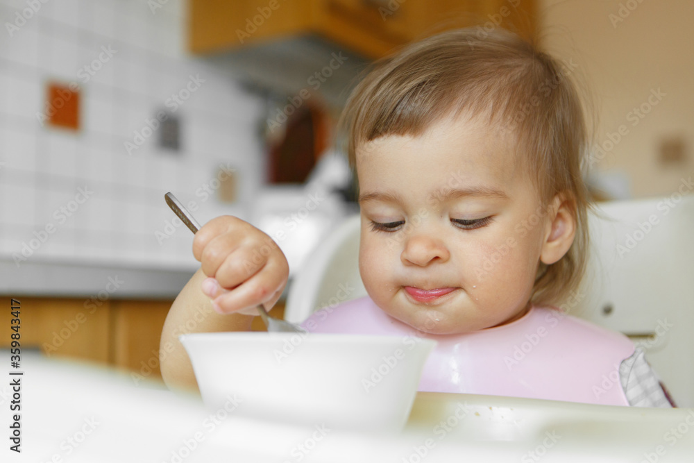 portrait of a child who eats baby food with his spoon. my face is smeared with food portrait of a child who eats baby food with his spoon. my face is smeared with food