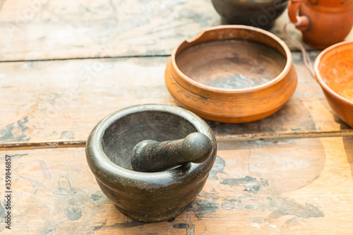 mortar bowl and pestle made of stone black traditional close-up for cooking potions