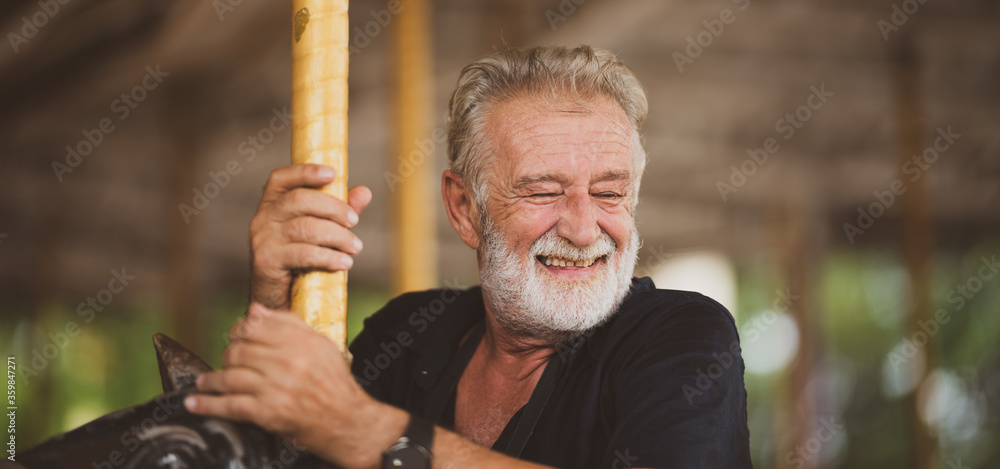 Senior father happy in theme park, old man smiling and enjoy relaxing at an amusement theme park Senior father happy in theme park, old man smiling and enjoy relaxing at an amusement theme park