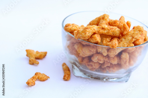 yummy tasty crunchy snacks drop from a transparent bowl