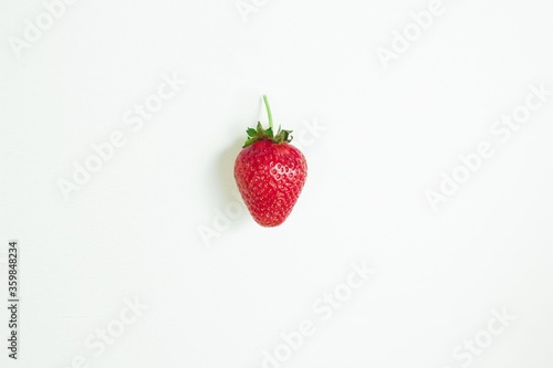 Fototapeta Naklejka Na Ścianę i Meble -  One ripe red strawberry on a white background