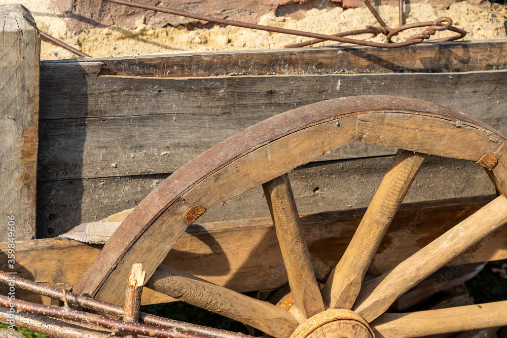 wooden trolley wheel traditional and beige and weathered closeup