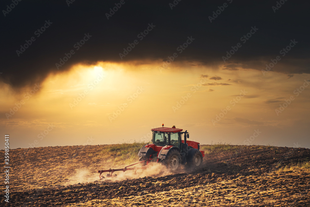 Tractor plowing the fields Tractor plowing the fields
