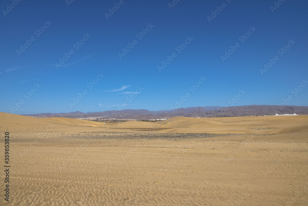 summer desert landscape on a warm sunny day from Maspalomas dunes on the Spanish island of Gran Canaria summer desert landscape on a warm sunny day from Maspalomas dunes on the Spanish island of Gran Canaria