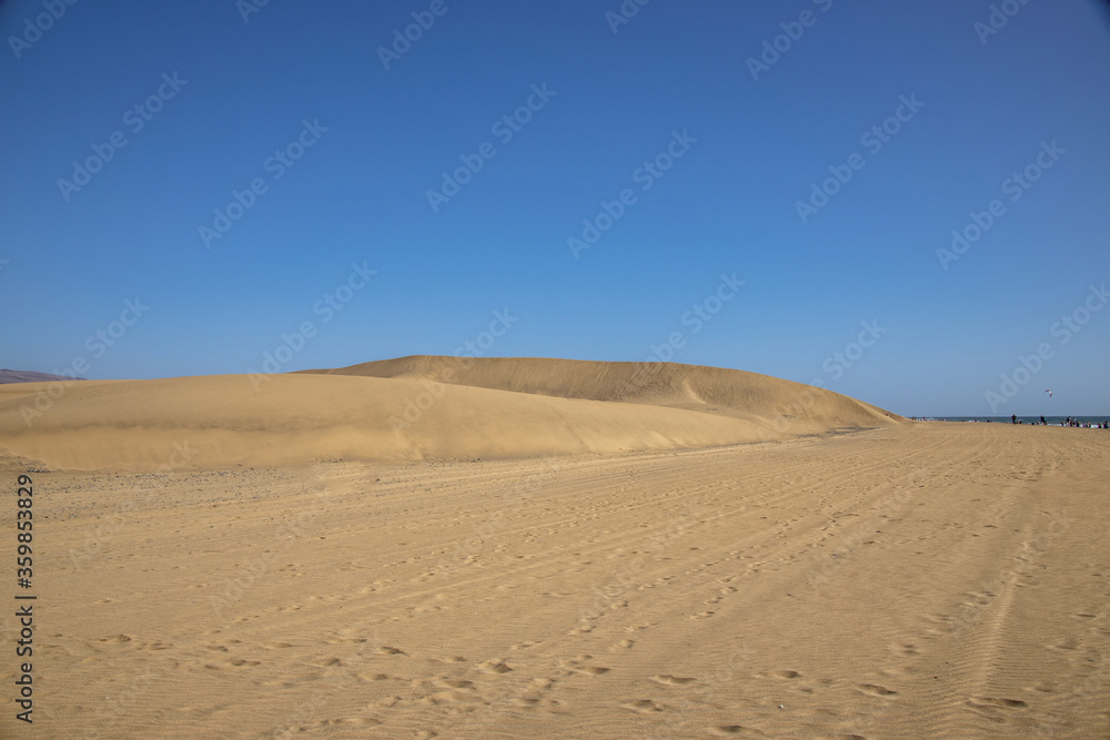 summer desert landscape on a warm sunny day from Maspalomas dunes on the Spanish island of Gran Canaria