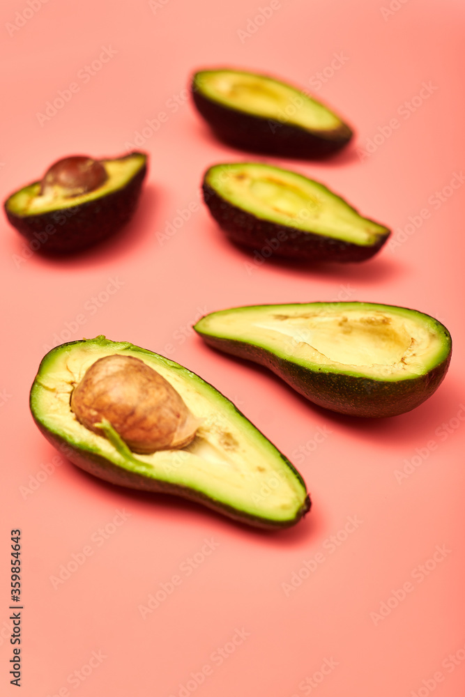 Sliced avocado on a pink background. Sliced avocado on a pink background.