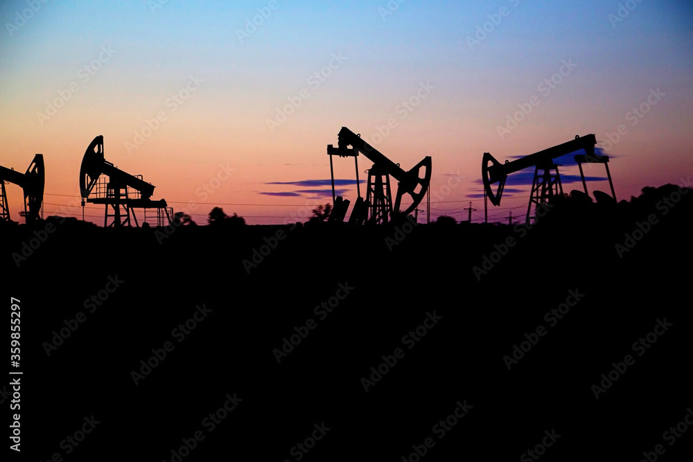 oil rig at sunset, at night, oil production in the world oil market oil rig at sunset, at night, oil production in the world oil market